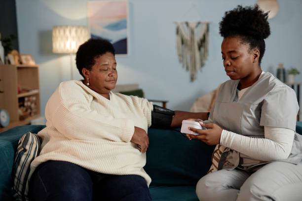 Caregiver assisting a client with a blood pressure check