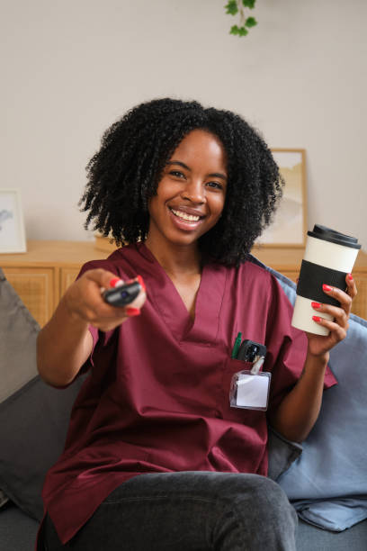 Smiling caregiver relaxing with a client at home