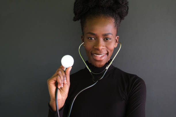 Smiling caregiver holding a stethoscope